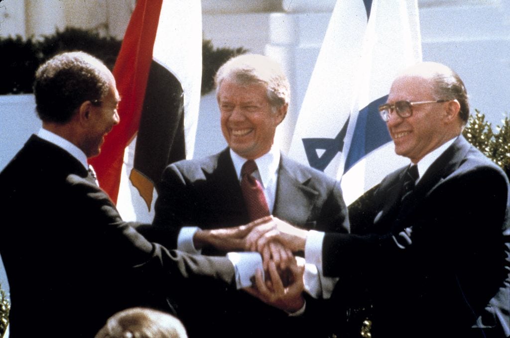 Anwar Sadat, Jimmy Carter, and Menachem Begin clasp hands at the White House as they sign the peace treaty between Egypt & Israel (AP/Bob Daugherty)